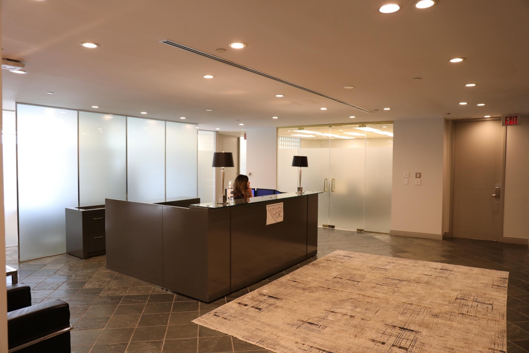 Office receptionist at front desk.